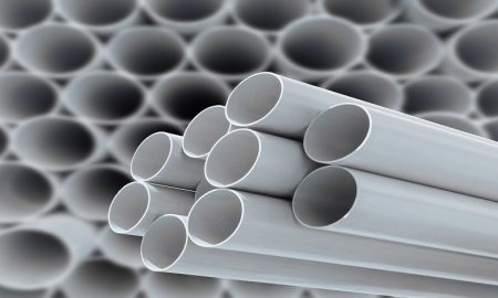 PVC pipes stacked in warehouse. PVC pipes stacked in warehouse.